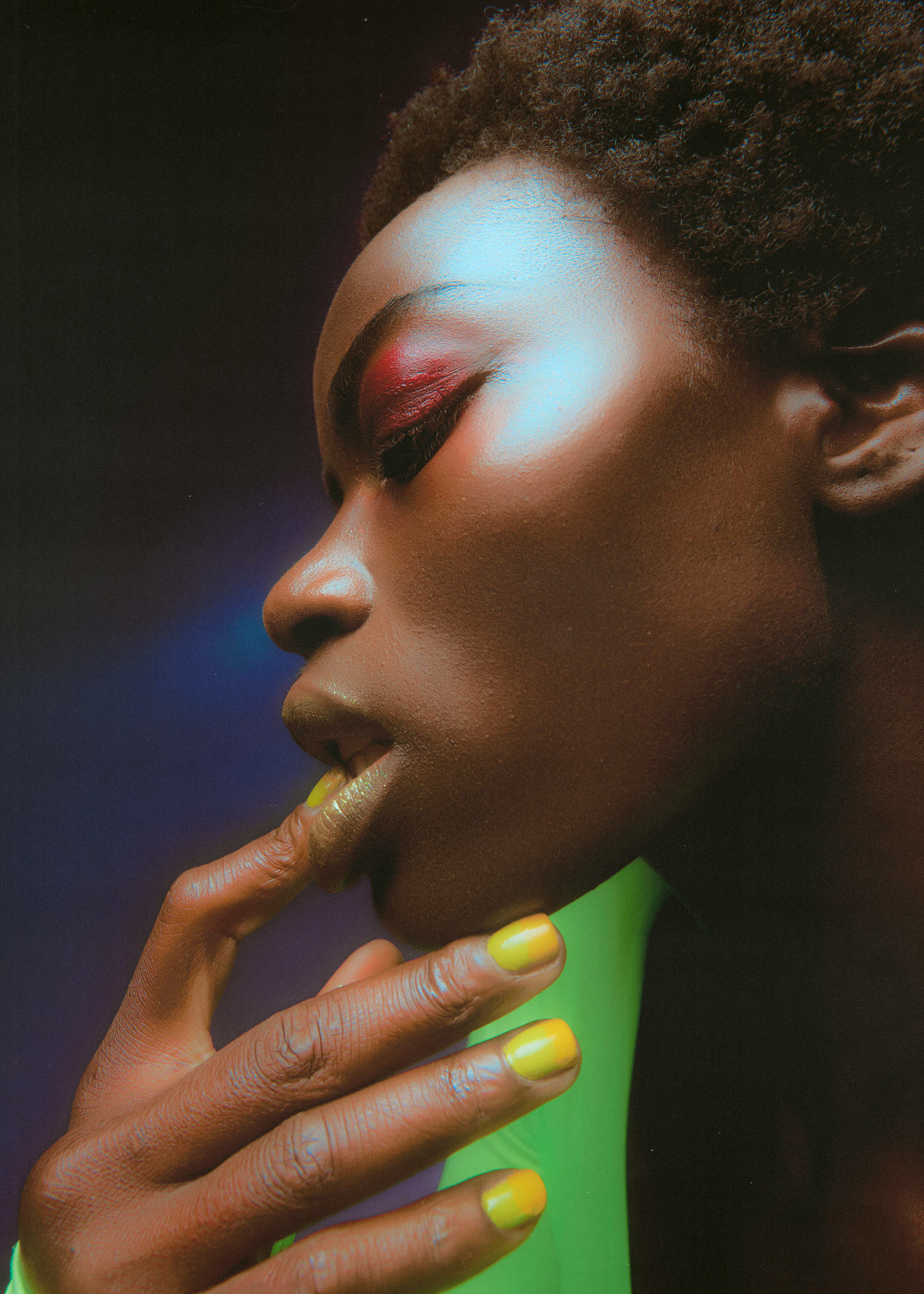 a black woman with bright yellow nails