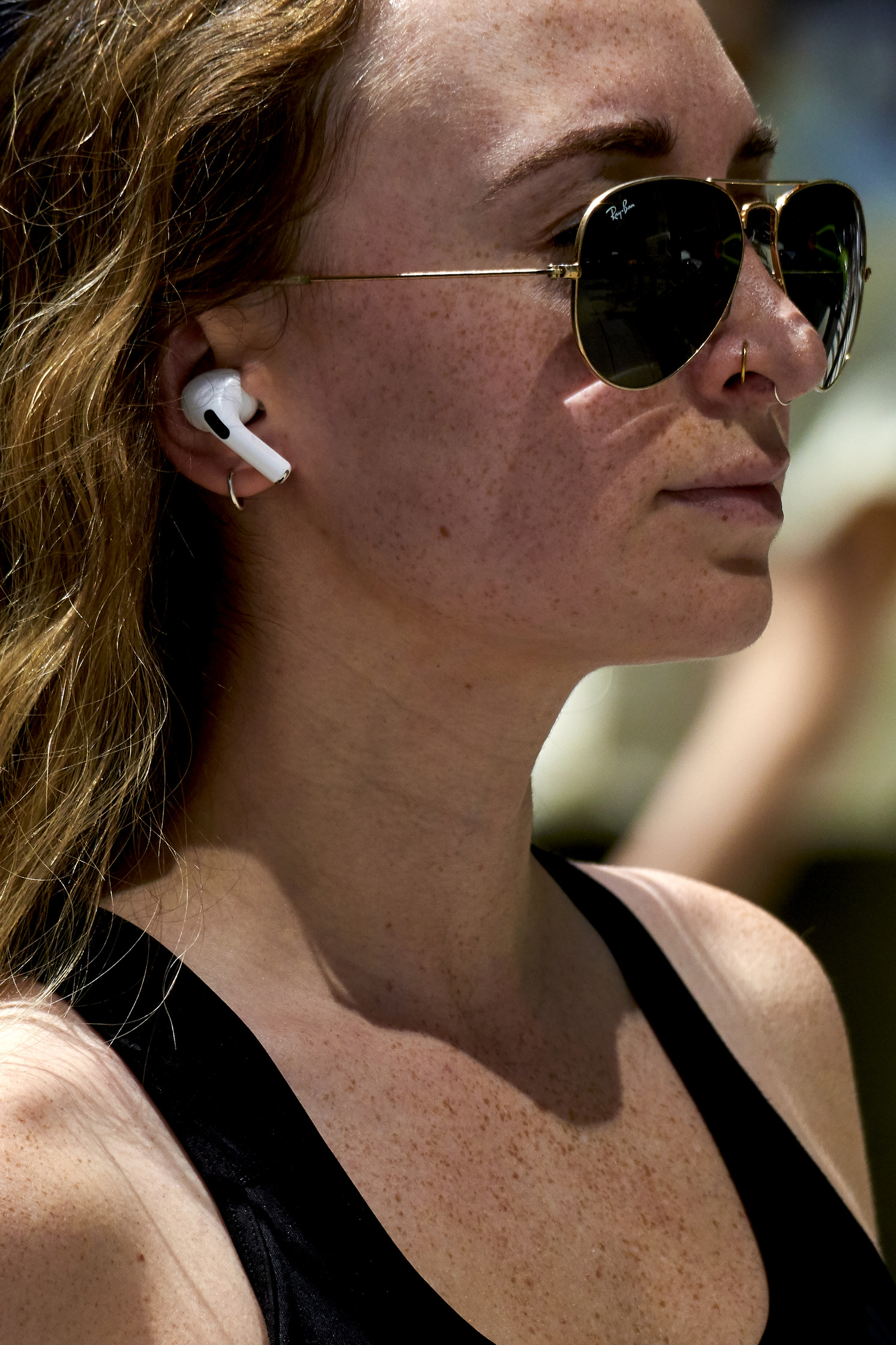 a woman wearing sunglasses and airpods
