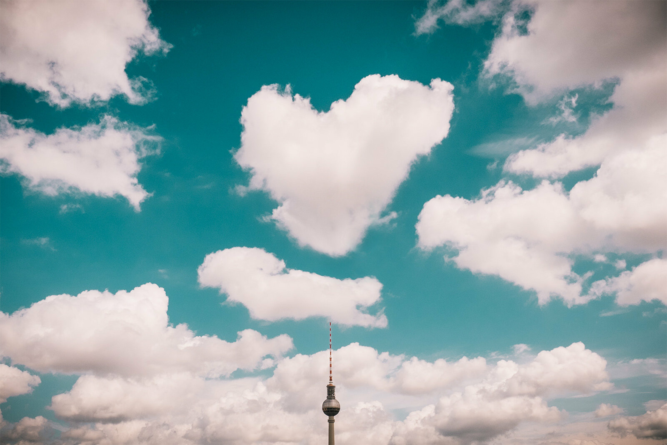 a heart shaped cloud in the sky above the berlin tv tower