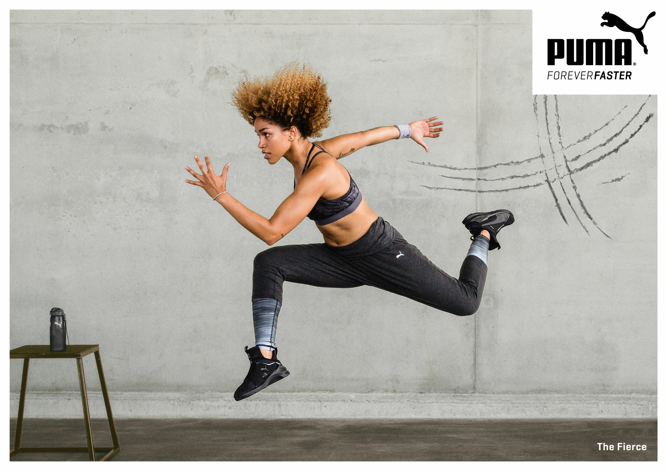 a woman is jumping in the air with a puma ad
