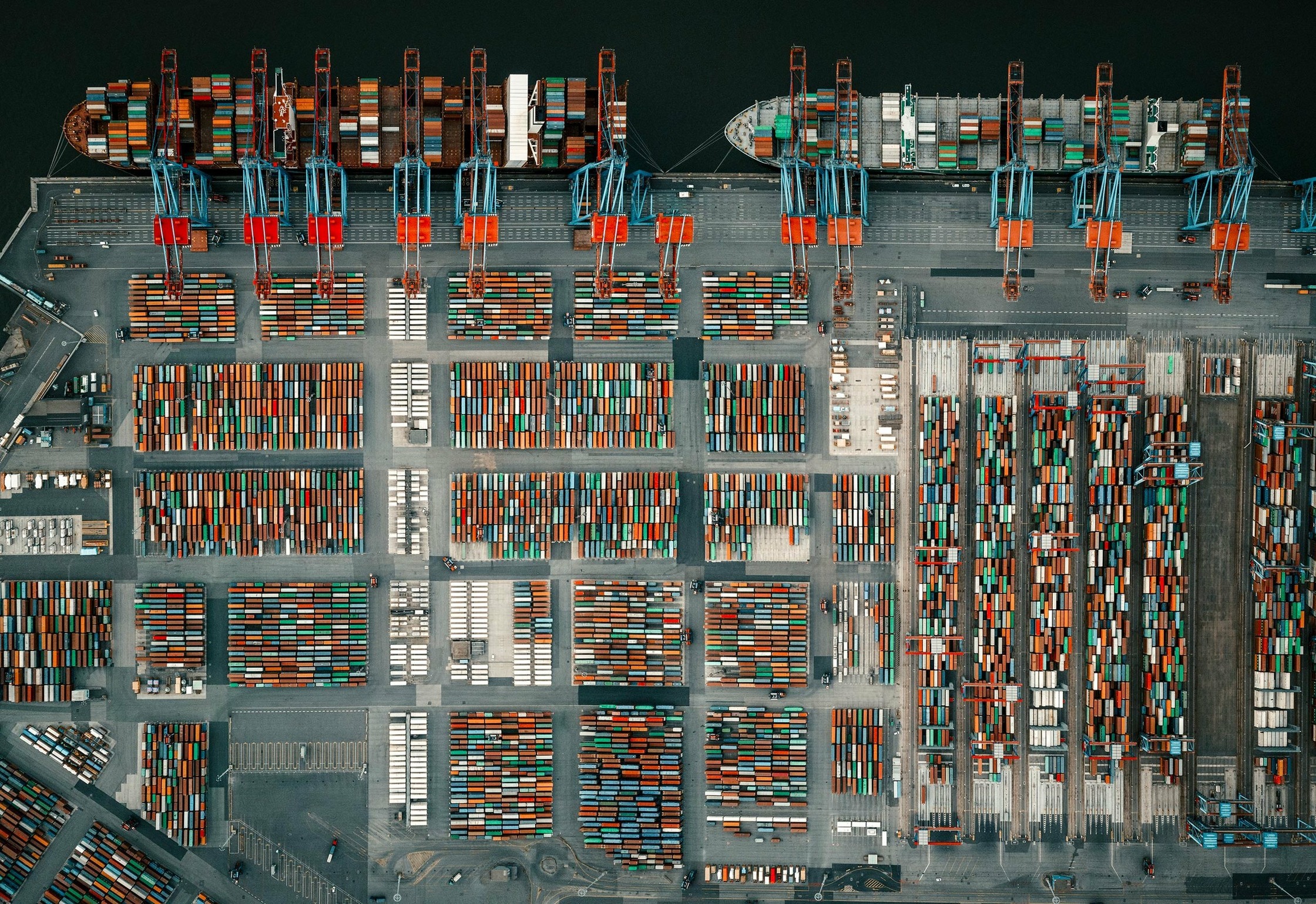 an aerial view of a container ship docked at a hamburg port