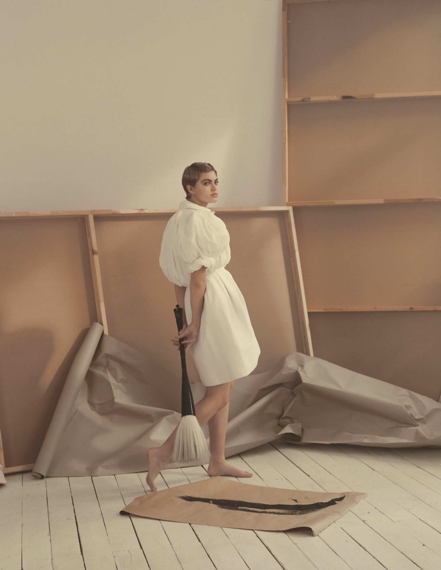 a woman standing in an empty room with a broom fashion photographer Fraukle Fischer