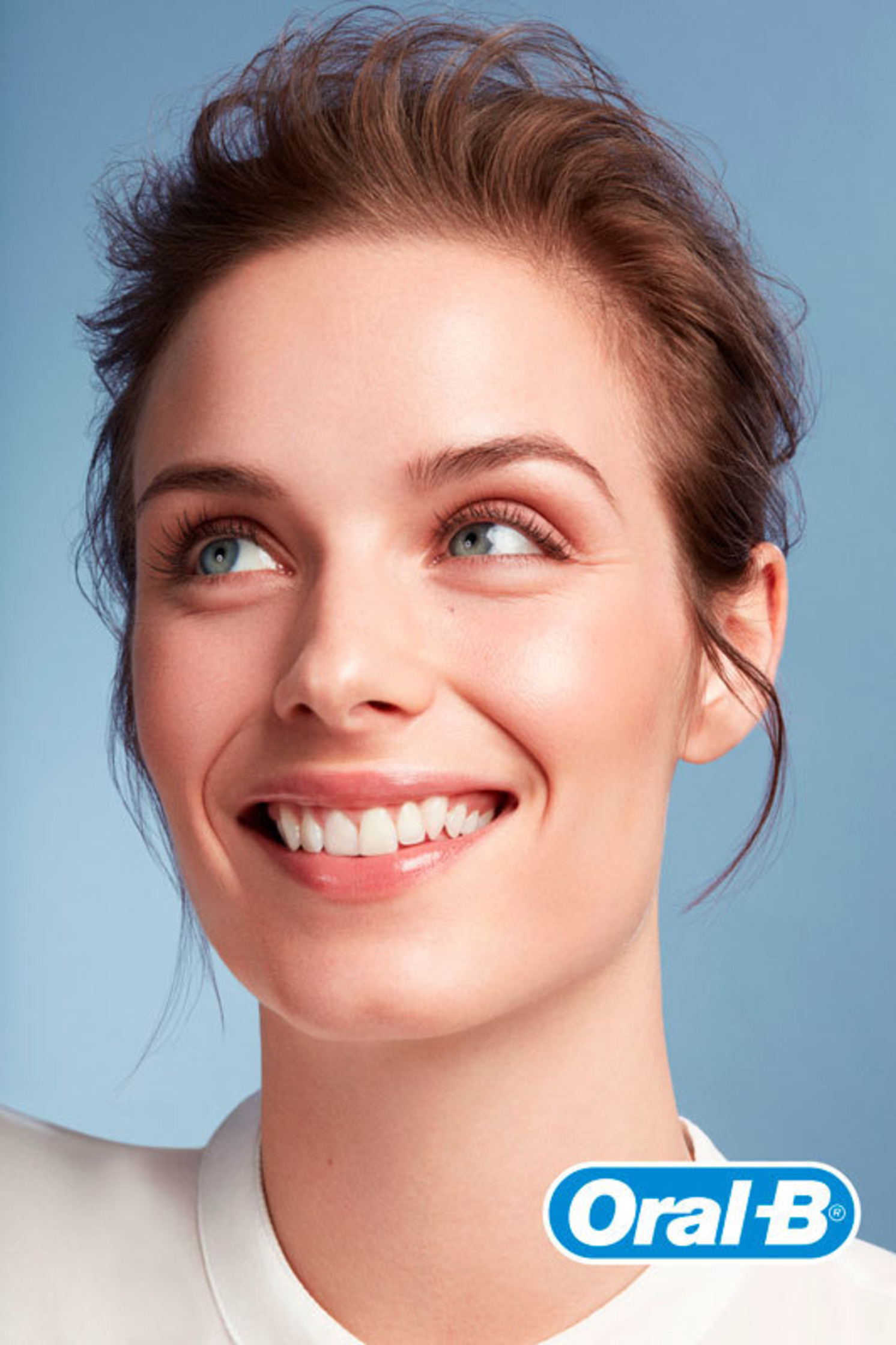 a woman smiles with an oral b product on her face for Oral B @fraukefischer