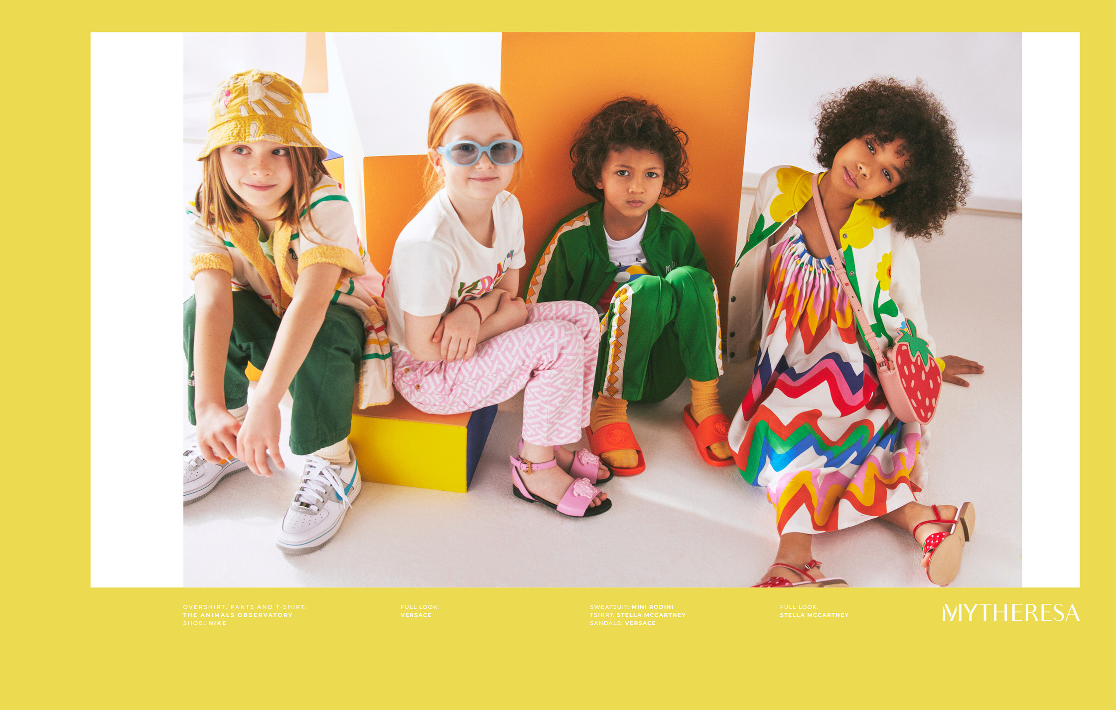 a group of children are posing in front of a colorful background