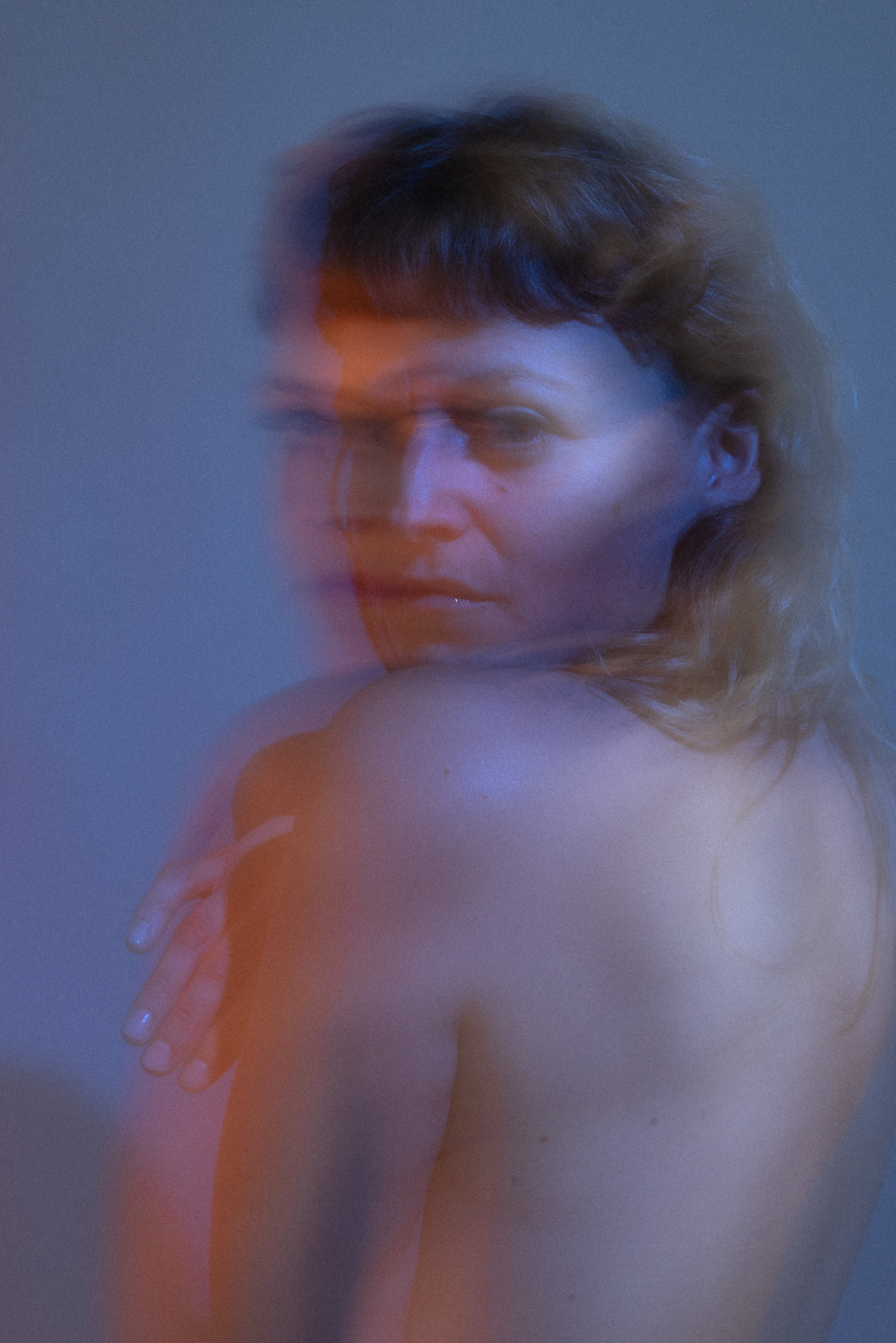 a blurry image of a  naked woman in blue and yellow