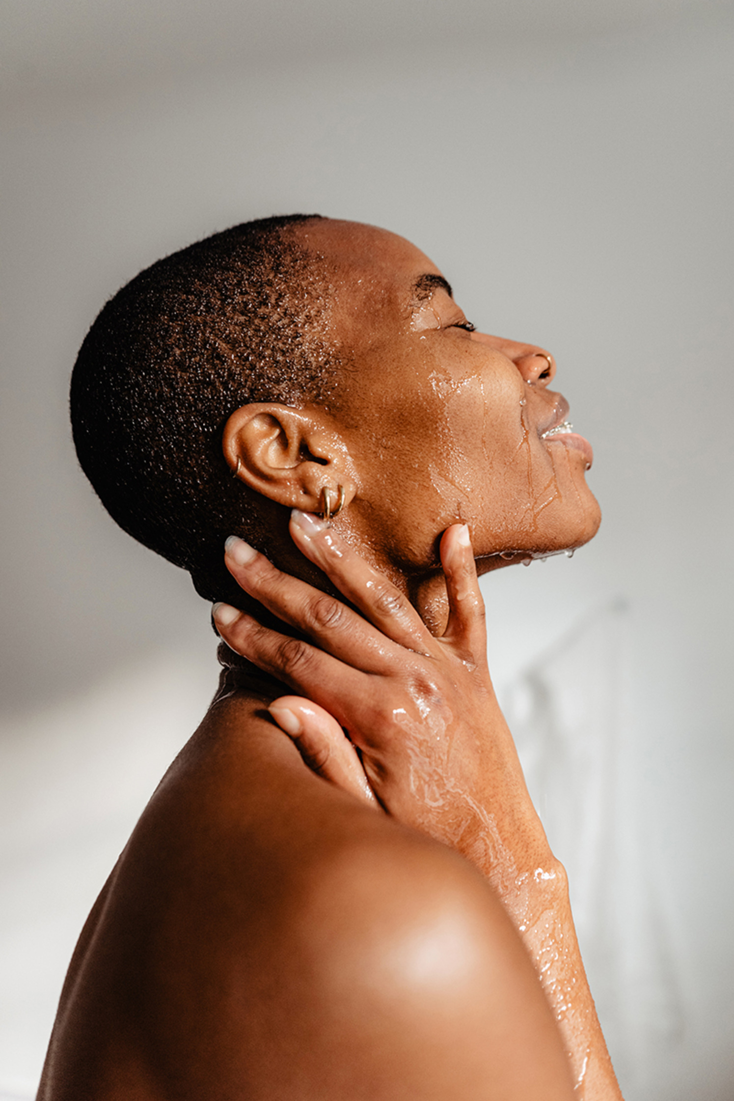 a woman touching her neck after having a shower