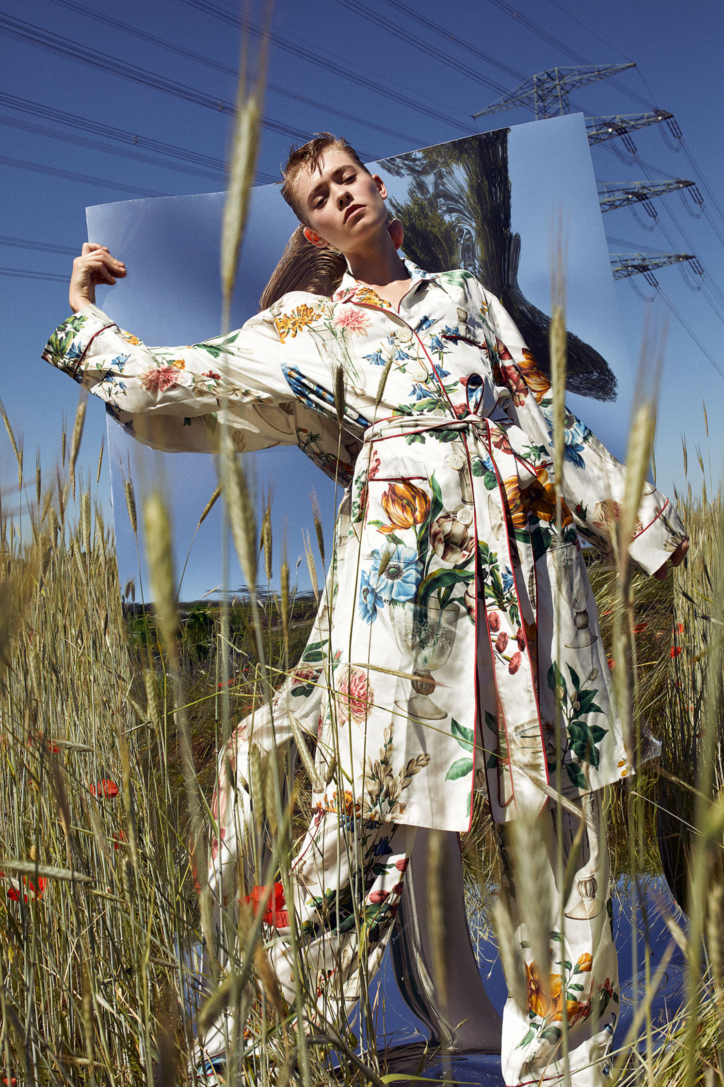 model maike inga  in a floral robe standing in a field