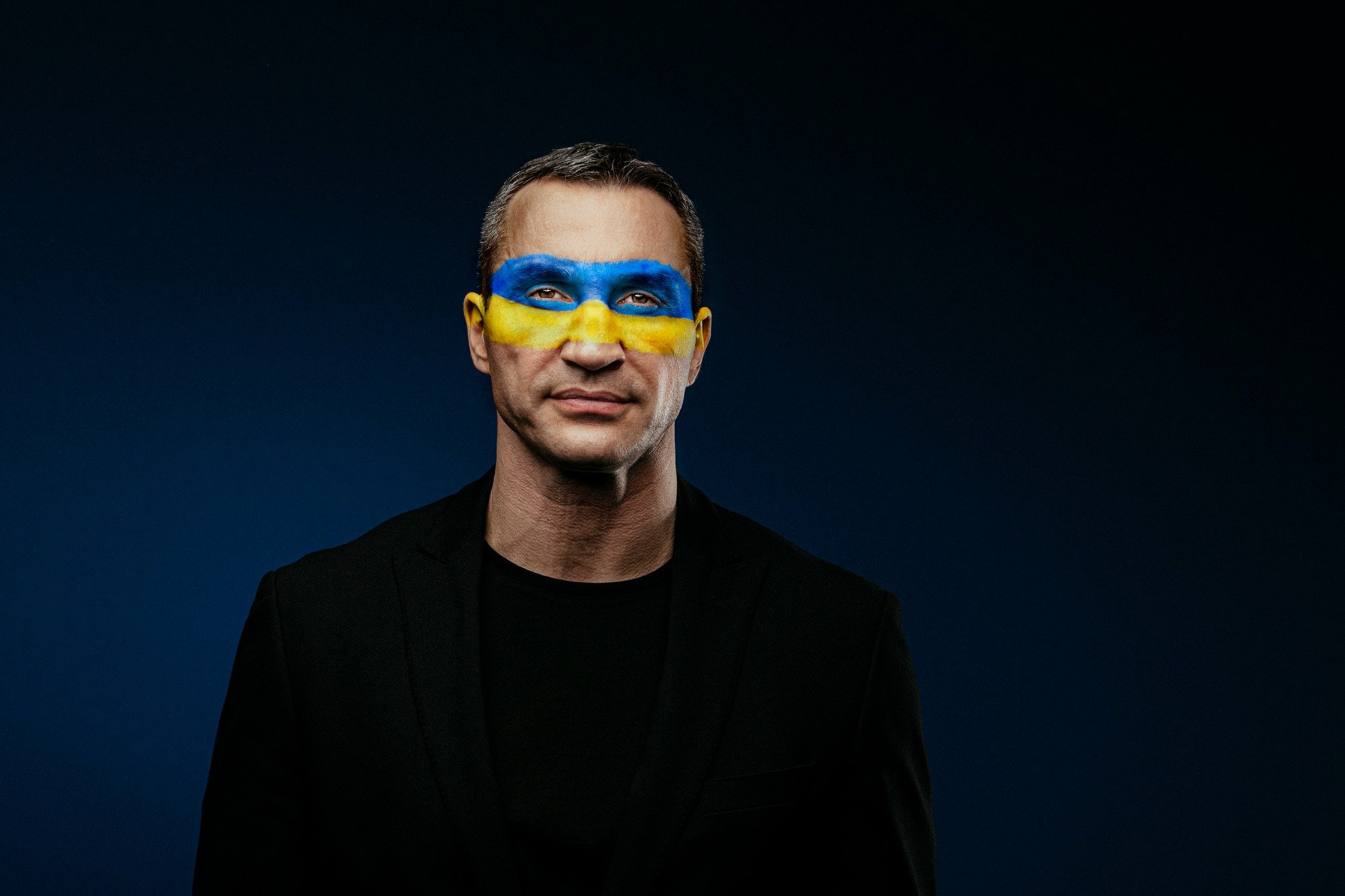a man with blue and yellow paint on his face, Wladimir Klitschko
