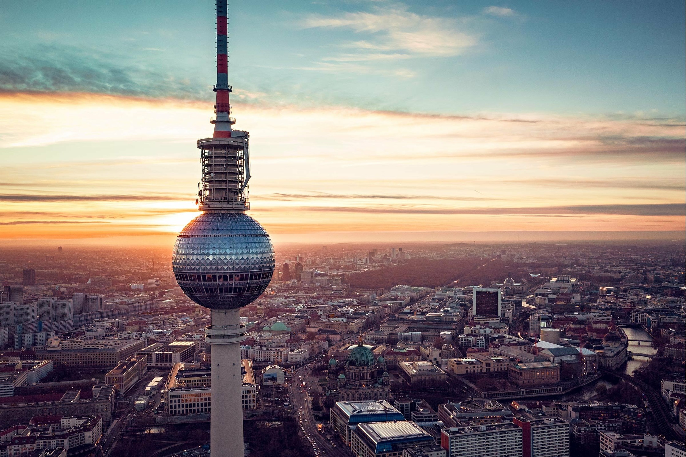 the tv tower in berlin at sunset