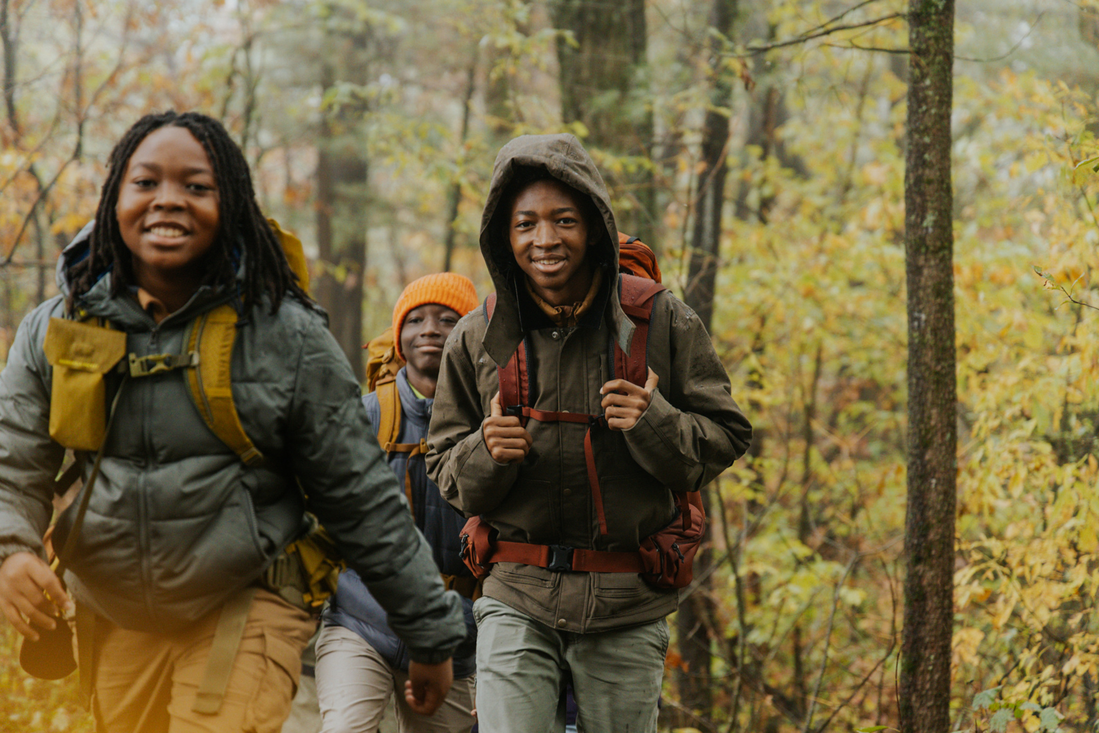 a group of young people hiking in the woods