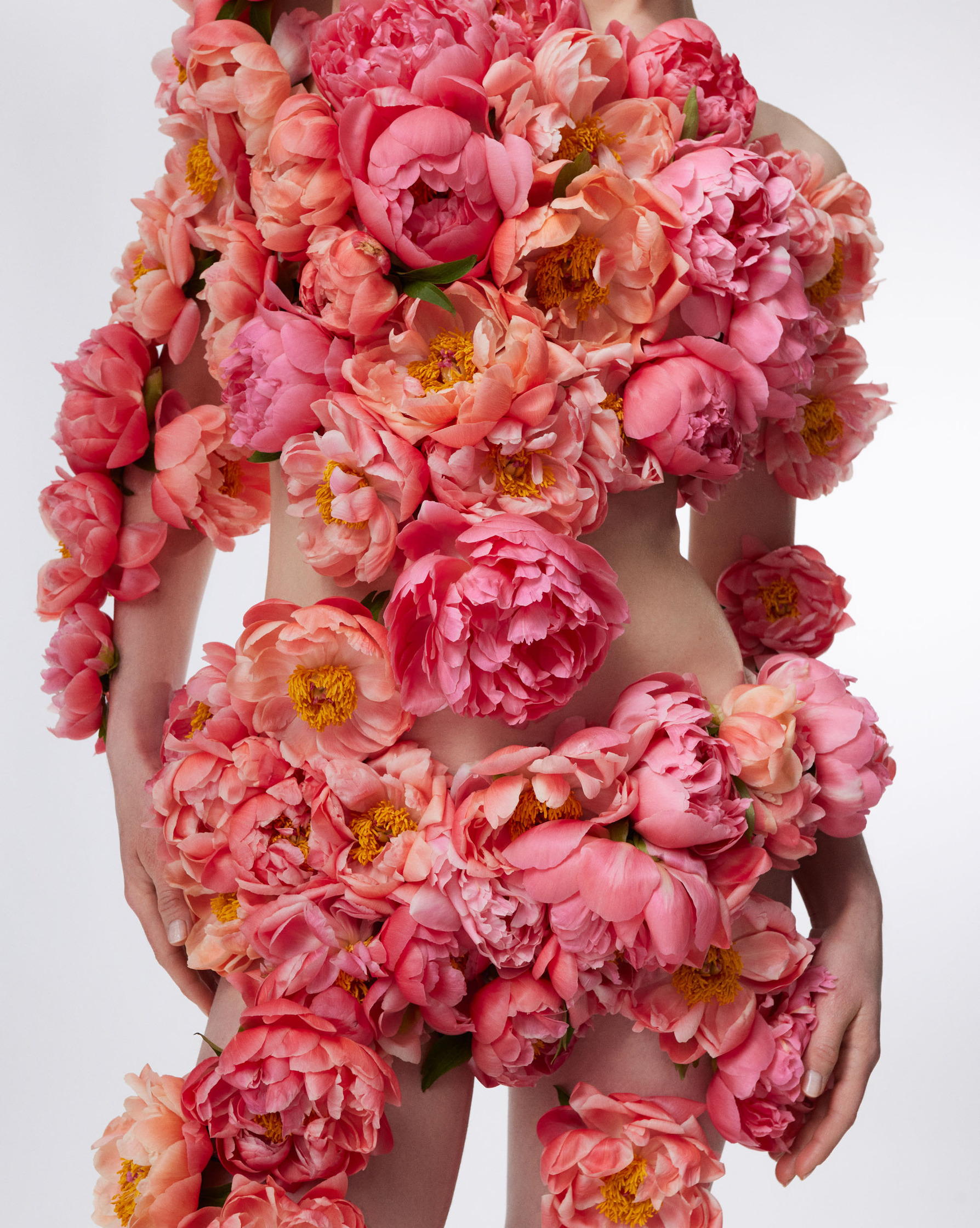 a woman posing with flowers on her body
