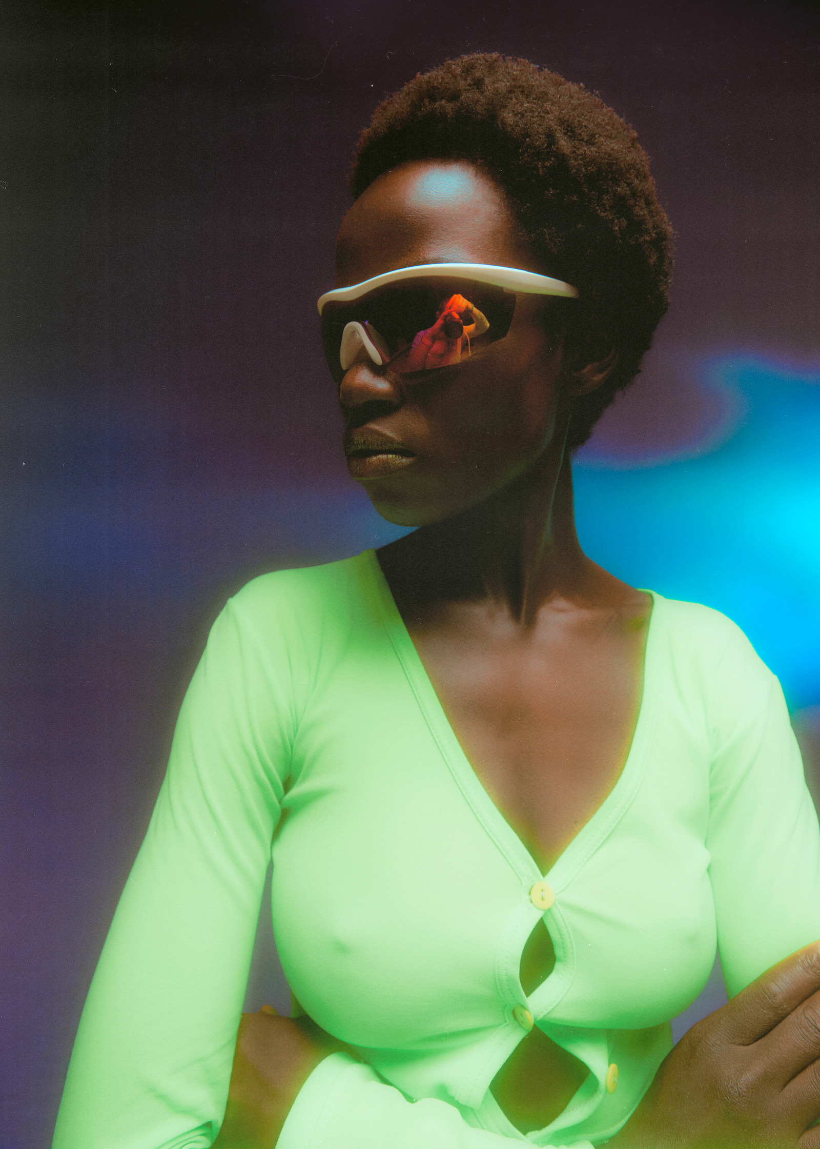 a woman in a green shirt with sunglasses