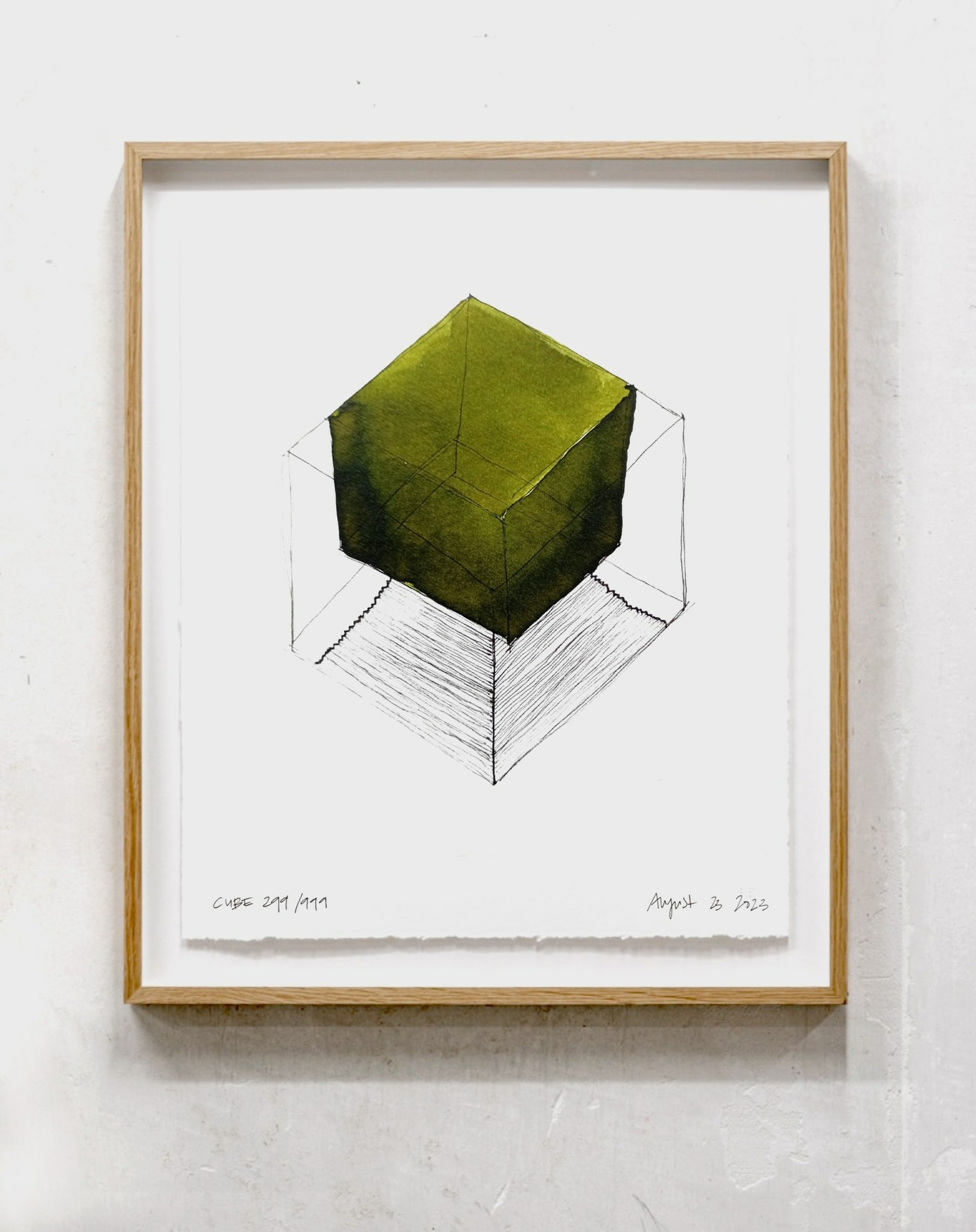 a drawing of a green cube hanging on a wall