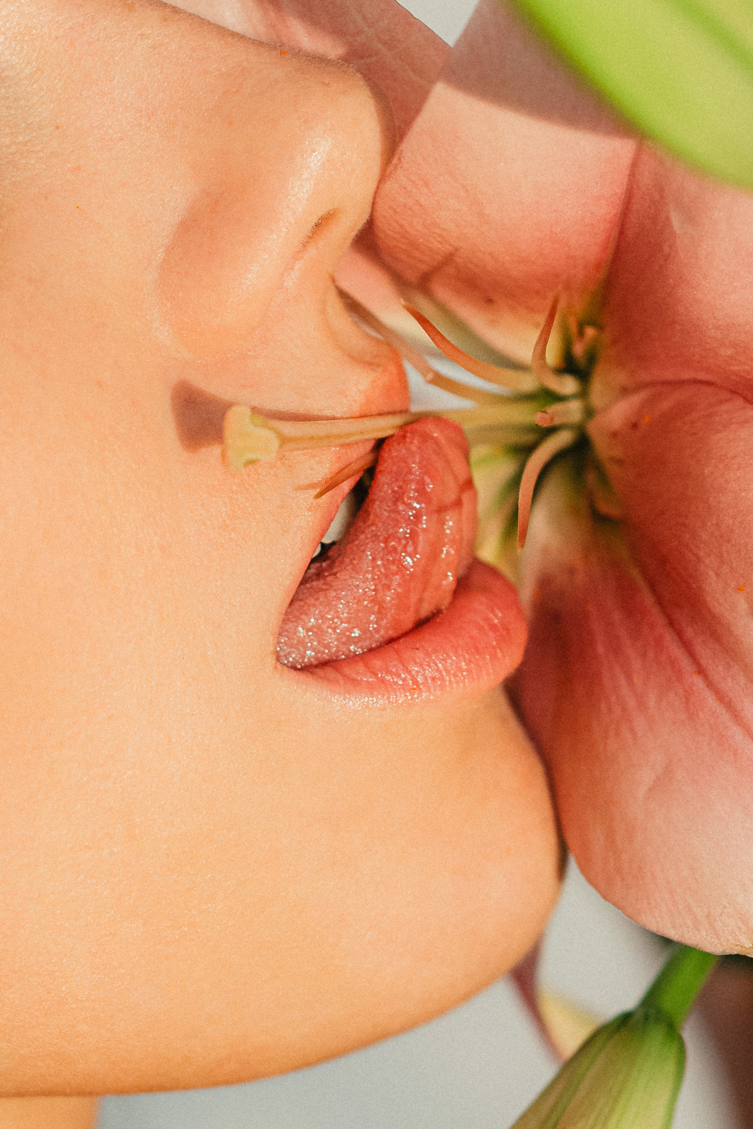 a woman is kissing and licking a flower